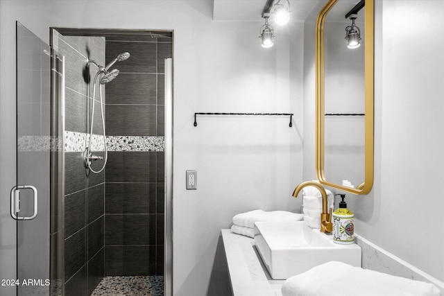 bathroom featuring sink and a shower with door