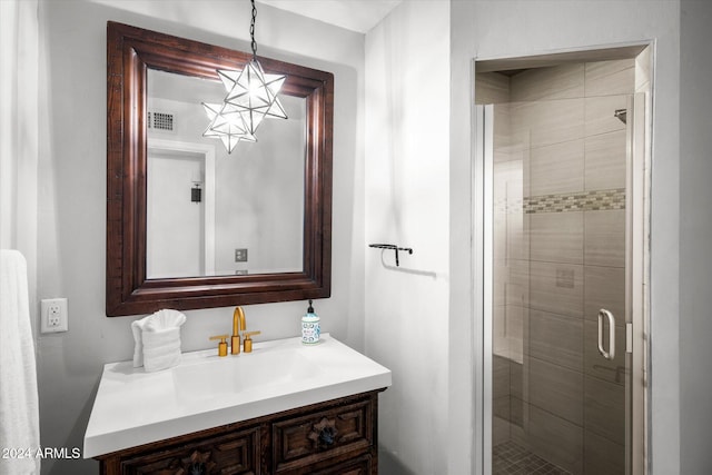 bathroom featuring vanity and a shower with shower door