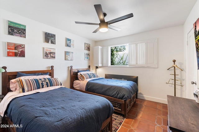 bedroom with tile patterned floors and ceiling fan