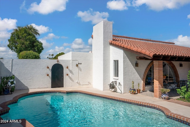 view of swimming pool with a patio area