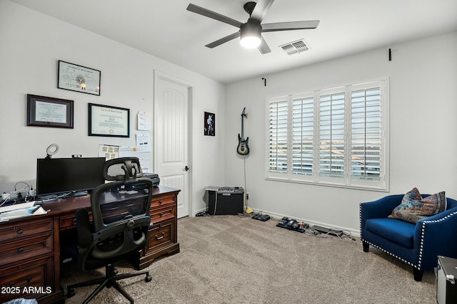 carpeted office featuring baseboards, visible vents, and a ceiling fan