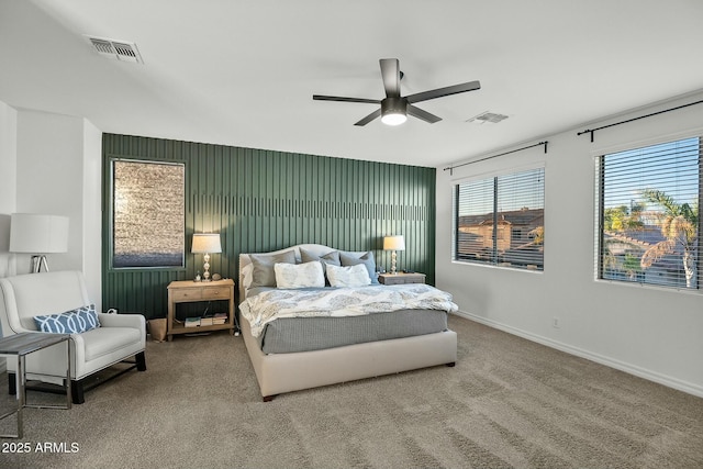 bedroom featuring ceiling fan, carpet flooring, visible vents, and baseboards