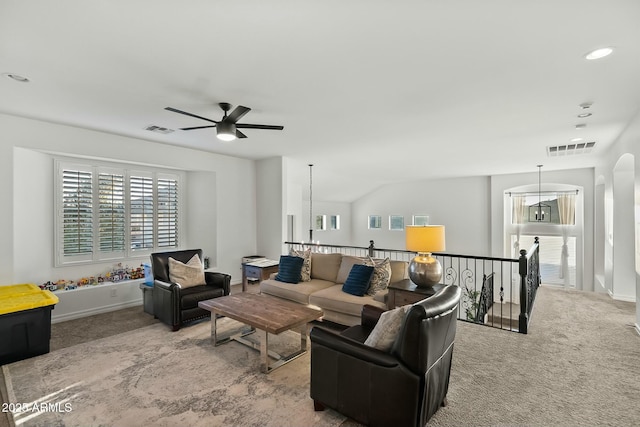 carpeted living room with baseboards, ceiling fan with notable chandelier, visible vents, and recessed lighting