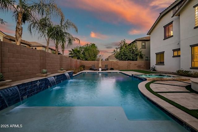 view of pool with a pool with connected hot tub and a fenced backyard