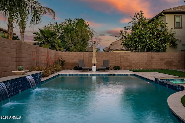 view of pool featuring a pool with connected hot tub and a fenced backyard