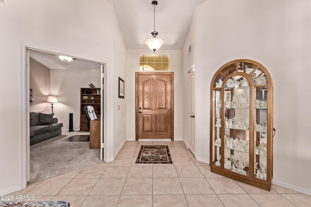 7648 W Mauna Loa Ln, Peoria, AZ 85381 - foyer entrance featuring high vaulted ceiling, light tile patterned flooring, and baseboards