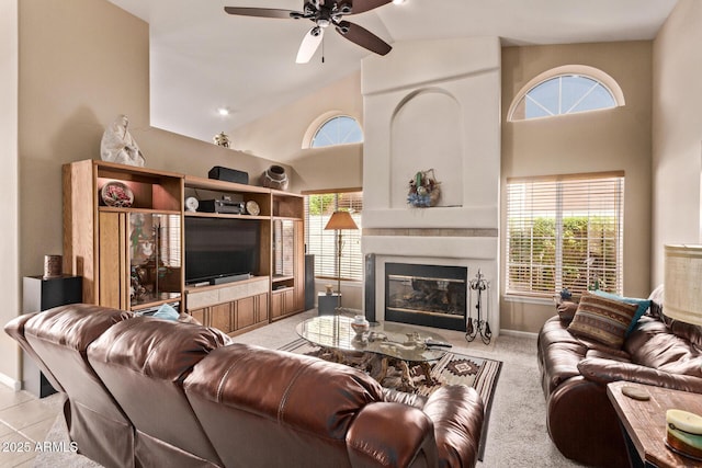 7648 W Mauna Loa Ln, Peoria, AZ 85381 - living room with a ceiling fan, high vaulted ceiling, baseboards, and a large fireplace