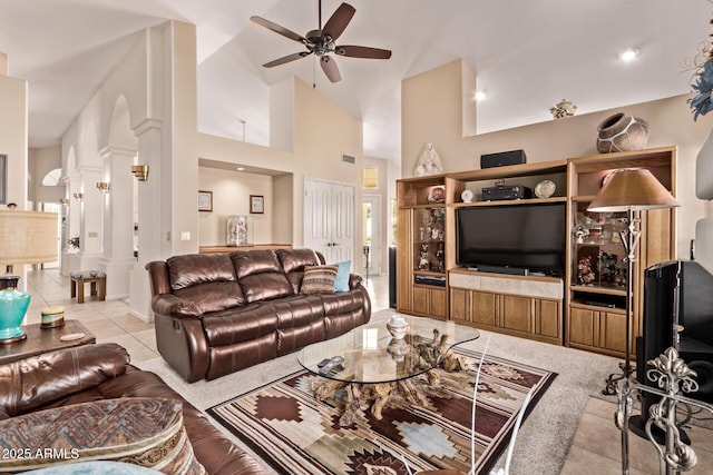 7648 W Mauna Loa Ln, Peoria, AZ 85381 - tiled living room with a ceiling fan, high vaulted ceiling, and decorative columns