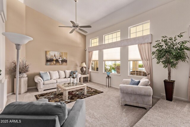 7648 W Mauna Loa Ln, Peoria, AZ 85381 - living area with carpet flooring, plenty of natural light, a ceiling fan, and a towering ceiling