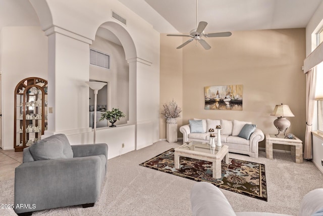 7648 W Mauna Loa Ln, Peoria, AZ 85381 - living room with a towering ceiling, arched walkways, a ceiling fan, carpet floors, and ornate columns