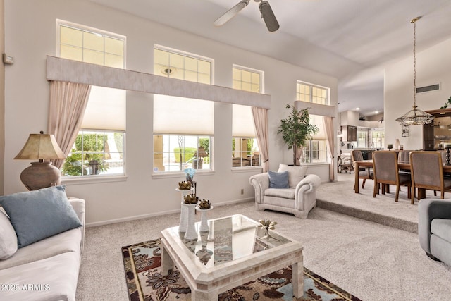 7648 W Mauna Loa Ln, Peoria, AZ 85381 - living room with carpet floors, ceiling fan, baseboards, and a high ceiling