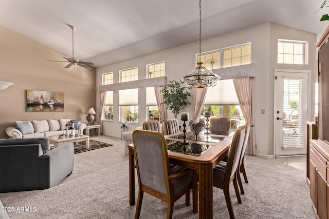 7648 W Mauna Loa Ln, Peoria, AZ 85381 - dining area with light colored carpet, high vaulted ceiling, a chandelier, a ceiling fan, and baseboards