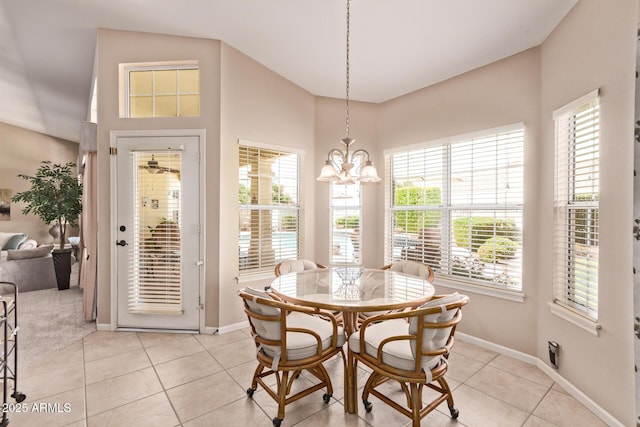 7648 W Mauna Loa Ln, Peoria, AZ 85381 - dining space featuring baseboards, light tile patterned flooring, a chandelier, and a towering ceiling