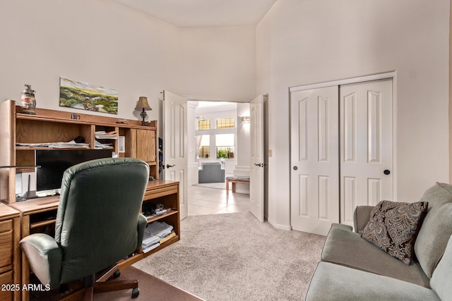 7648 W Mauna Loa Ln, Peoria, AZ 85381 - carpeted home office featuring a towering ceiling and tile patterned floors