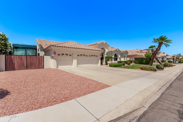 7648 W Mauna Loa Ln, Peoria, AZ 85381 - mediterranean / spanish house with an attached garage, stucco siding, concrete driveway, fence, and a tiled roof