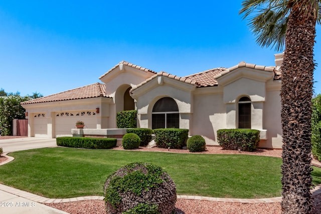 7648 W Mauna Loa Ln, Peoria, AZ 85381 - mediterranean / spanish-style house with stucco siding, an attached garage, a tiled roof, and a front lawn