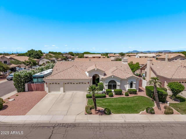 7648 W Mauna Loa Ln, Peoria, AZ 85381 - mediterranean / spanish house with an attached garage, stucco siding, concrete driveway, a front lawn, and a tile roof