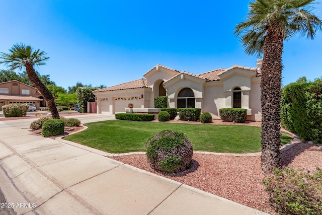 7648 W Mauna Loa Ln, Peoria, AZ 85381 - mediterranean / spanish-style home with an attached garage, stucco siding, a tiled roof, concrete driveway, and a front lawn
