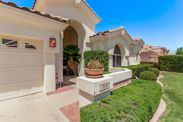 7648 W Mauna Loa Ln, Peoria, AZ 85381 - view of side of property featuring a tiled roof, stucco siding, and an attached garage