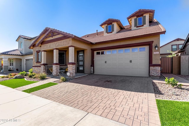 view of front of home featuring a porch and a garage