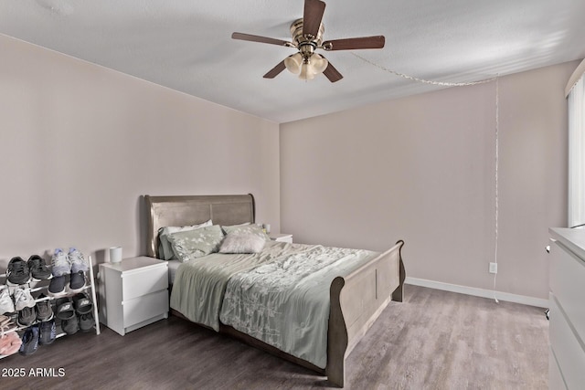 7474 E Earll Dr Unit 311, Scottsdale, AZ 85251 - bedroom with wood finished floors, ceiling fan, and baseboards