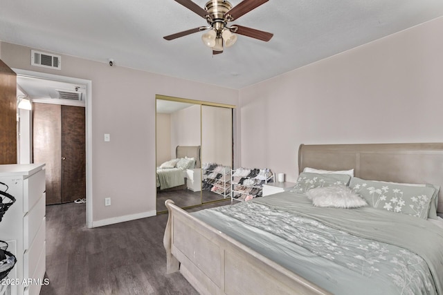 7474 E Earll Dr Unit 311, Scottsdale, AZ 85251 - bedroom featuring dark wood finished floors, a closet, baseboards, and ceiling fan