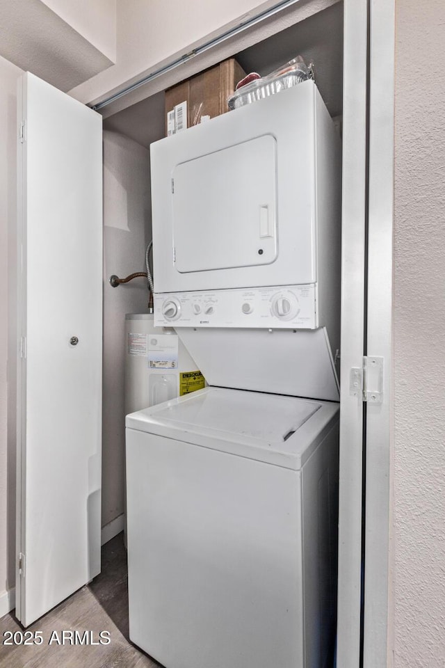 7474 E Earll Dr Unit 311, Scottsdale, AZ 85251 - laundry room featuring stacked washer / dryer, water heater, and wood finished floors