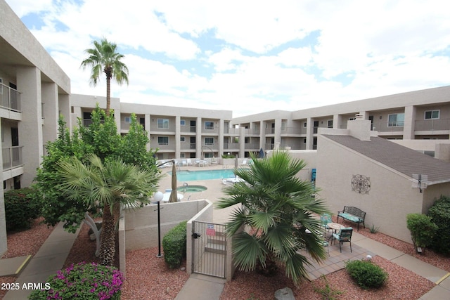 7474 E Earll Dr Unit 311, Scottsdale, AZ 85251 - view of building exterior featuring a community pool and fence