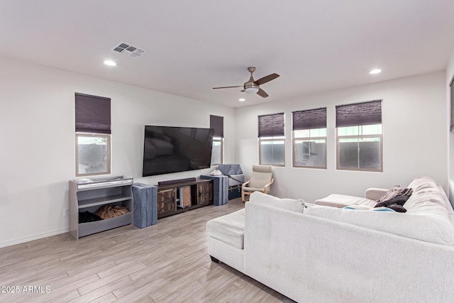 living room with ceiling fan and light hardwood / wood-style floors