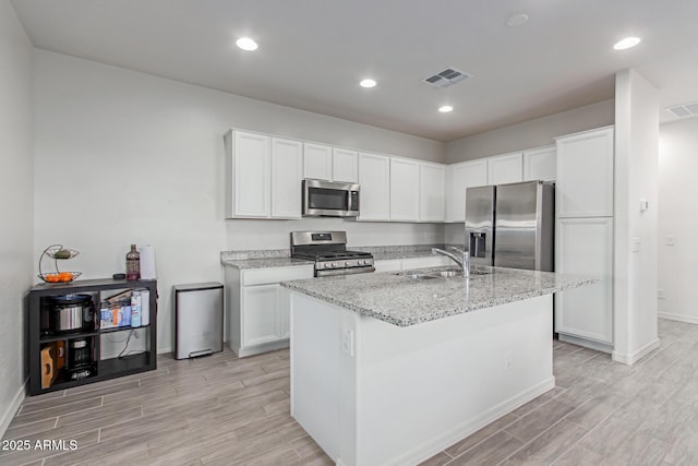 3714 S 58th Dr, Phoenix, AZ 85043 - kitchen with appliances with stainless steel finishes, wood finish floors, a sink, baseboards, and light stone countertops