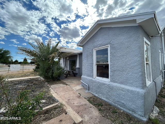 view of side of property featuring a patio