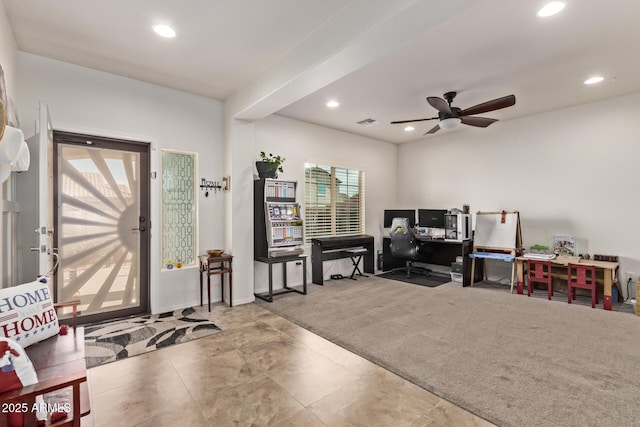 entryway with ceiling fan and carpet flooring