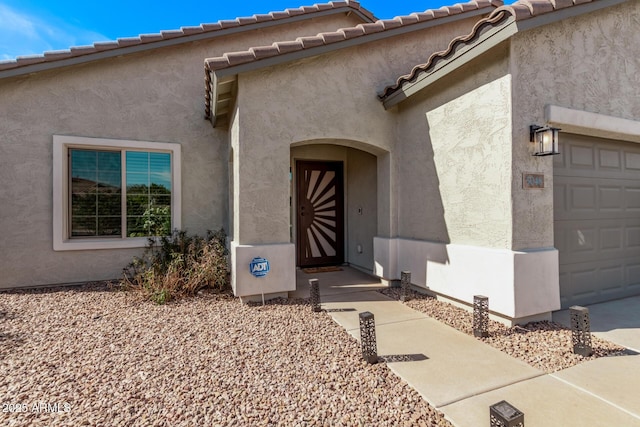 view of exterior entry featuring a garage