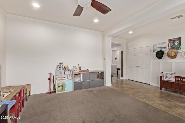 miscellaneous room featuring ceiling fan and dark carpet