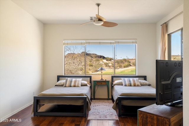 bedroom with visible vents, dark wood finished floors, baseboards, and ceiling fan