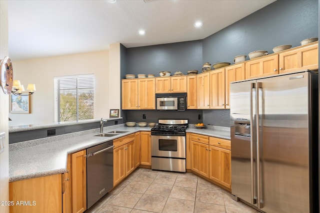 kitchen featuring light tile patterned floors, stainless steel appliances, a sink, and light countertops