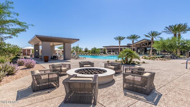 view of patio / terrace with a community pool and a fire pit