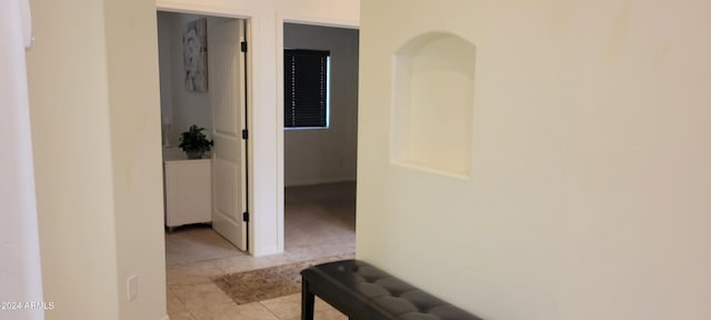 corridor with light tile patterned flooring