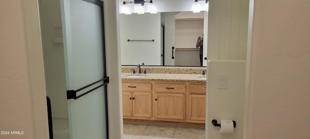 bathroom featuring tile patterned flooring and vanity