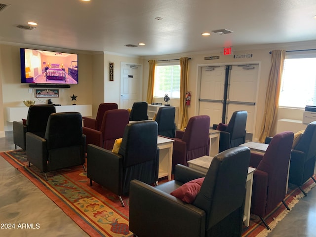 home theater room featuring crown molding