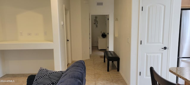 hallway featuring light tile patterned floors