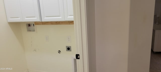 laundry room featuring electric dryer hookup, cabinets, and washer hookup