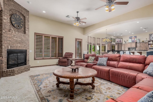 21615 E Pegasus Pkwy, Queen Creek, AZ 85142 - living area featuring a fireplace, recessed lighting, light carpet, and ceiling fan with notable chandelier