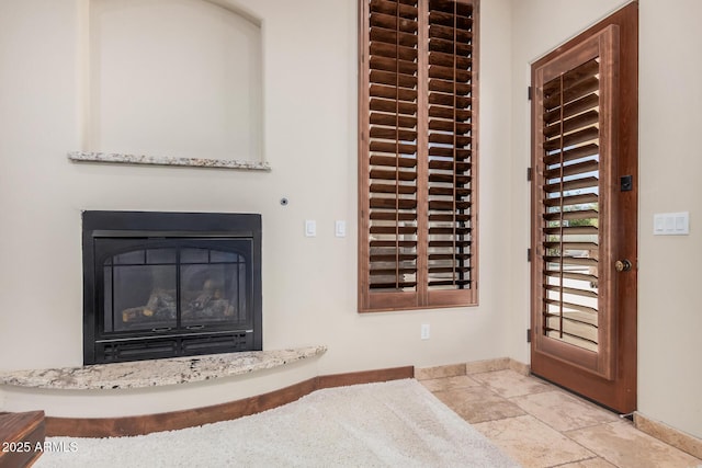 21615 E Pegasus Pkwy, Queen Creek, AZ 85142 - details featuring a glass covered fireplace and baseboards