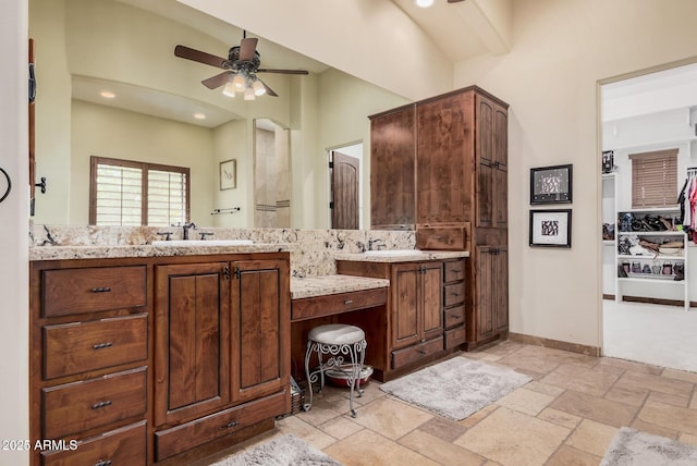21615 E Pegasus Pkwy, Queen Creek, AZ 85142 - bathroom featuring vanity, ceiling fan, stone tile flooring, baseboards, and recessed lighting