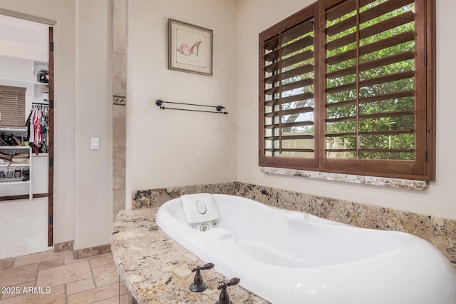 21615 E Pegasus Pkwy, Queen Creek, AZ 85142 - full bathroom featuring stone tile floors and a tub with jets