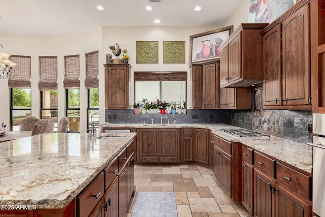 21615 E Pegasus Pkwy, Queen Creek, AZ 85142 - kitchen featuring a sink, stainless steel gas cooktop, decorative backsplash, stone tile floors, and recessed lighting