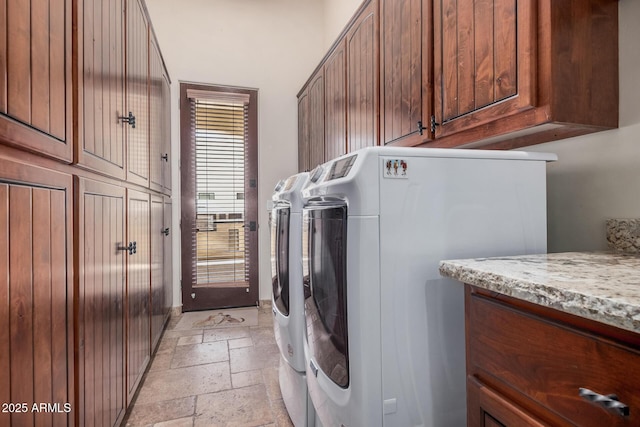 21615 E Pegasus Pkwy, Queen Creek, AZ 85142 - washroom featuring stone tile floors, washing machine and dryer, and cabinet space