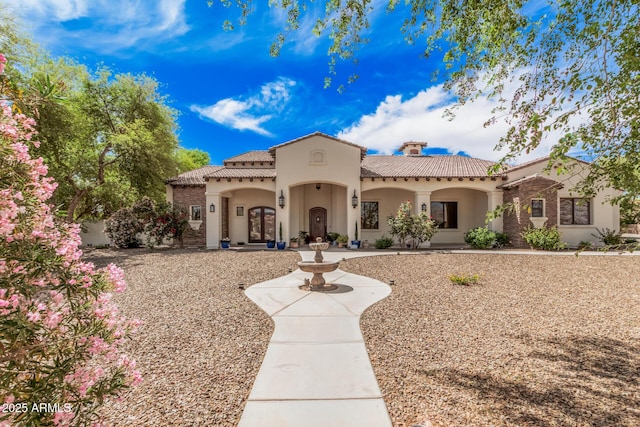 21615 E Pegasus Pkwy, Queen Creek, AZ 85142 - mediterranean / spanish-style house featuring a tile roof, a chimney, french doors, and stucco siding