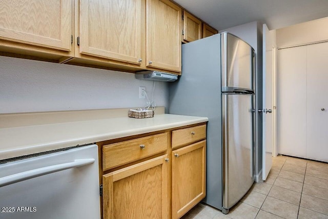 kitchen with appliances with stainless steel finishes, light brown cabinetry, and light tile patterned floors